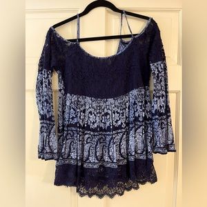 Navy blue cold shoulder bell sleeve top with lace detail.